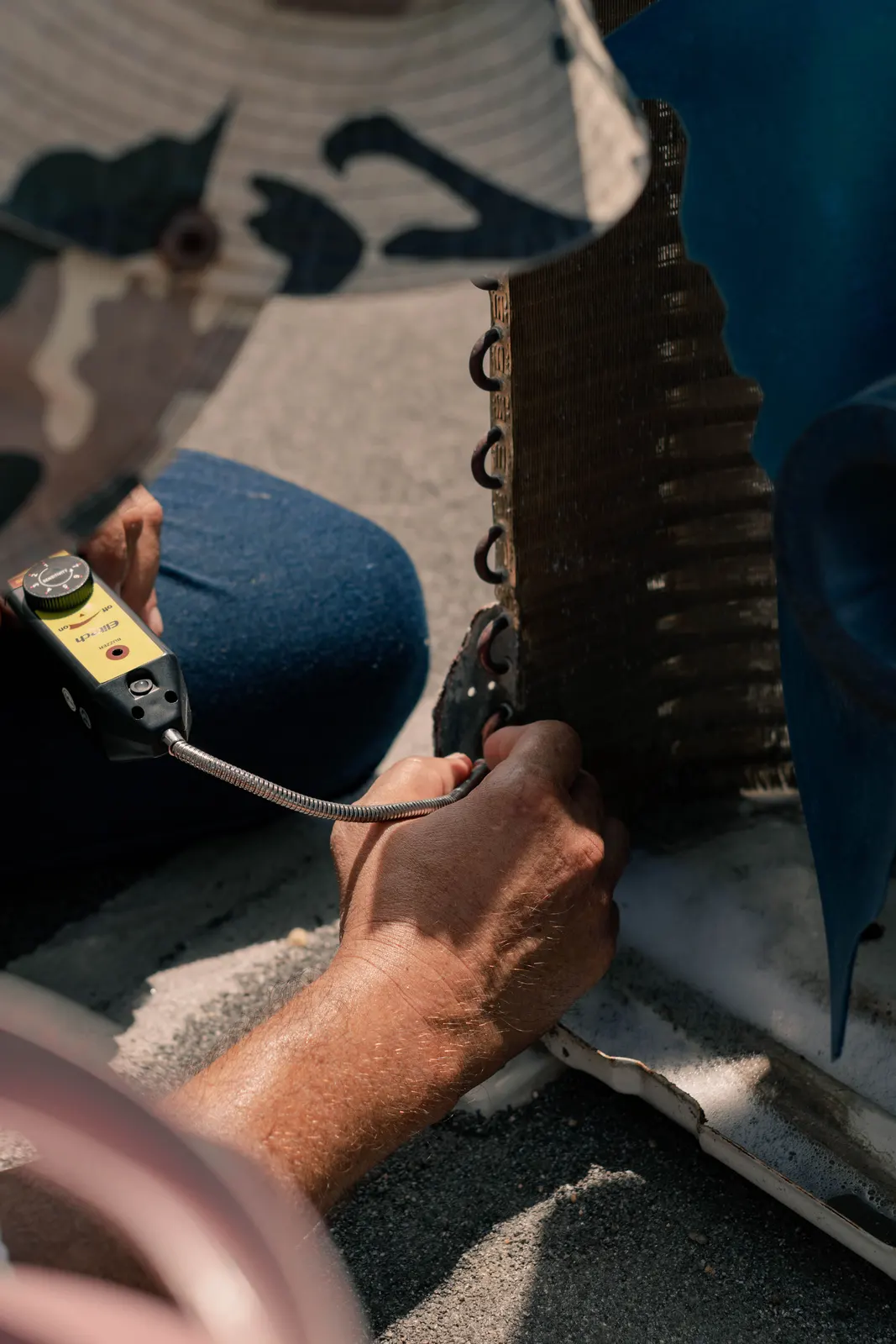 Technician diagnosing an outdoor air conditioning unit