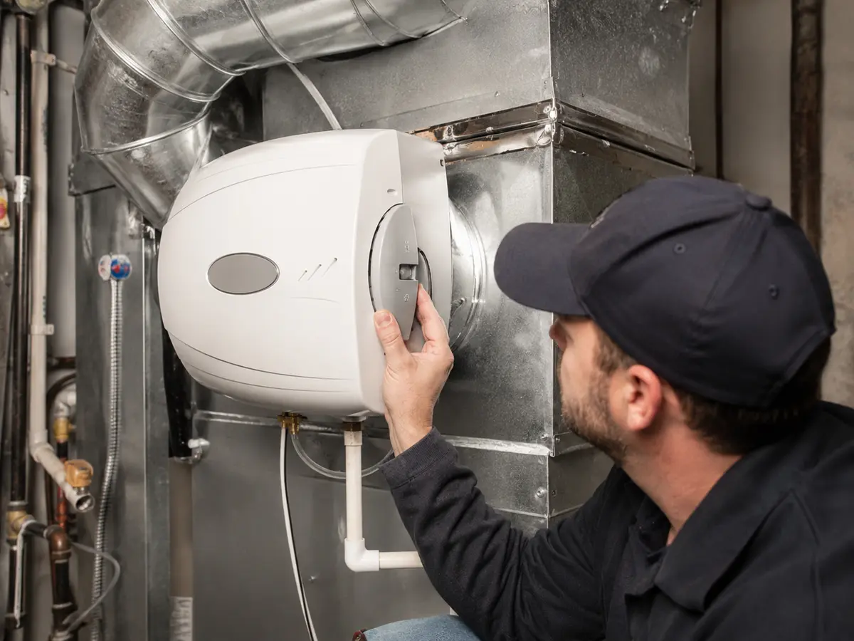 Technician replacing a residential HVAC air filter